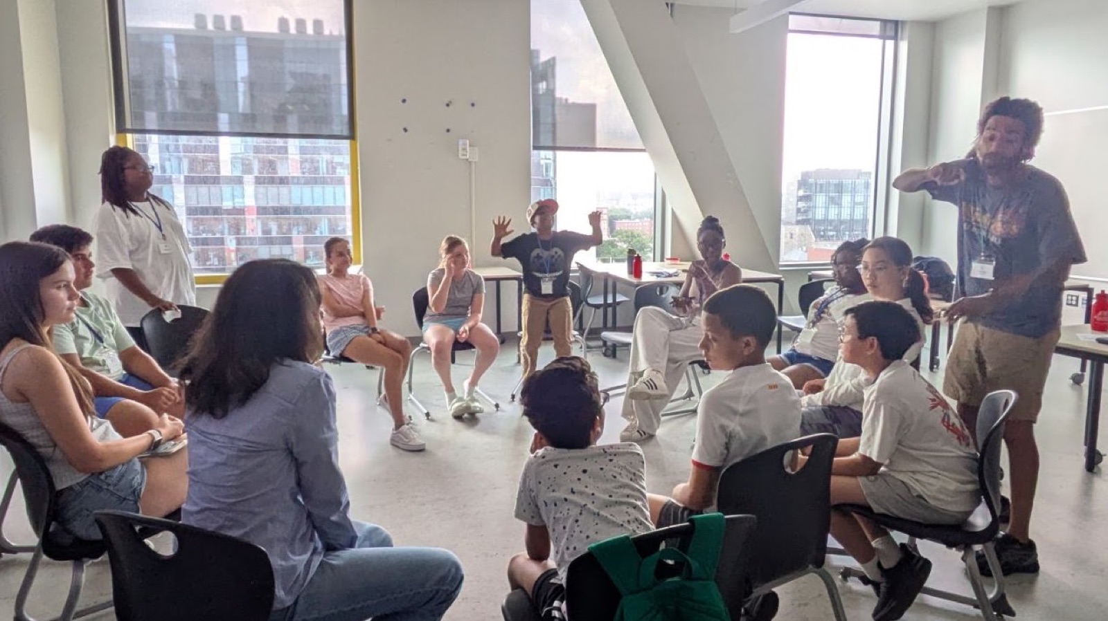 Campers and two facilitators take part in a whole-group discussion circle.