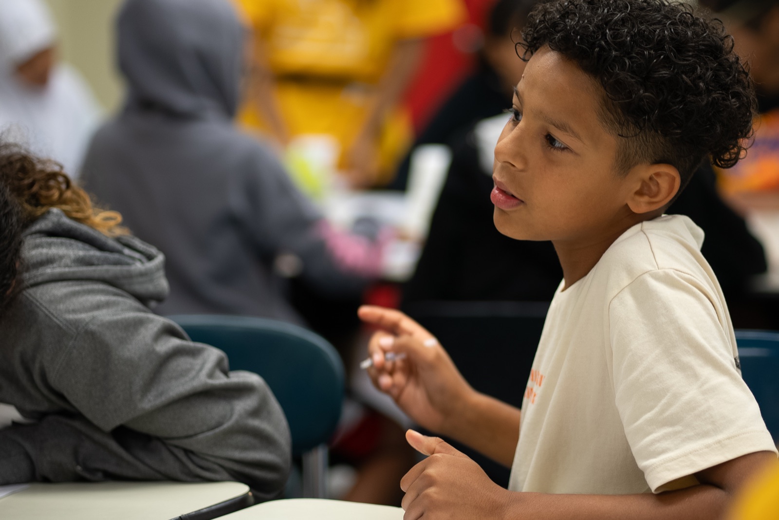 A middle school camper speaks during a Boston Debate League camp activity.