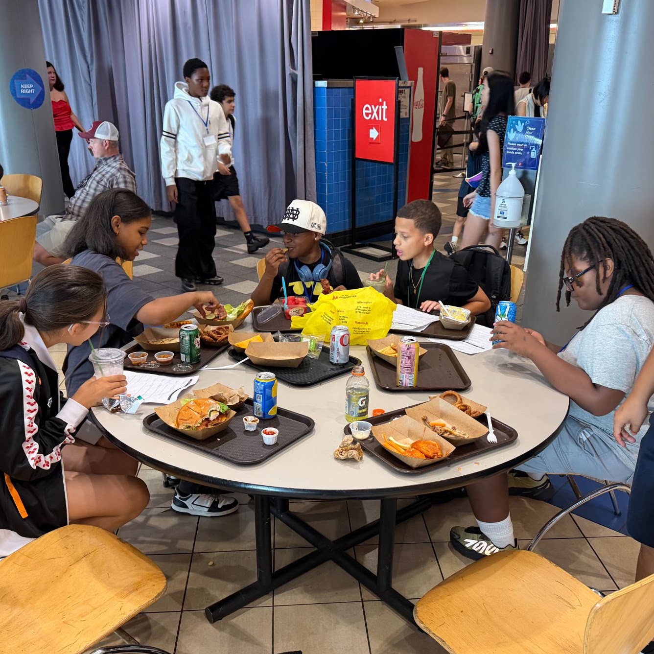 Campers eat lunch together around a table during Boston Debate League summer camp.